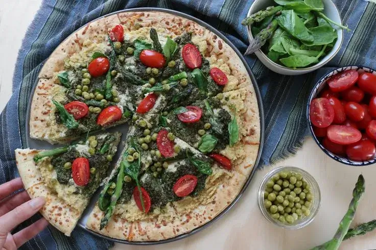 The Green Goddess pizza with pesto and fresh vegetables.