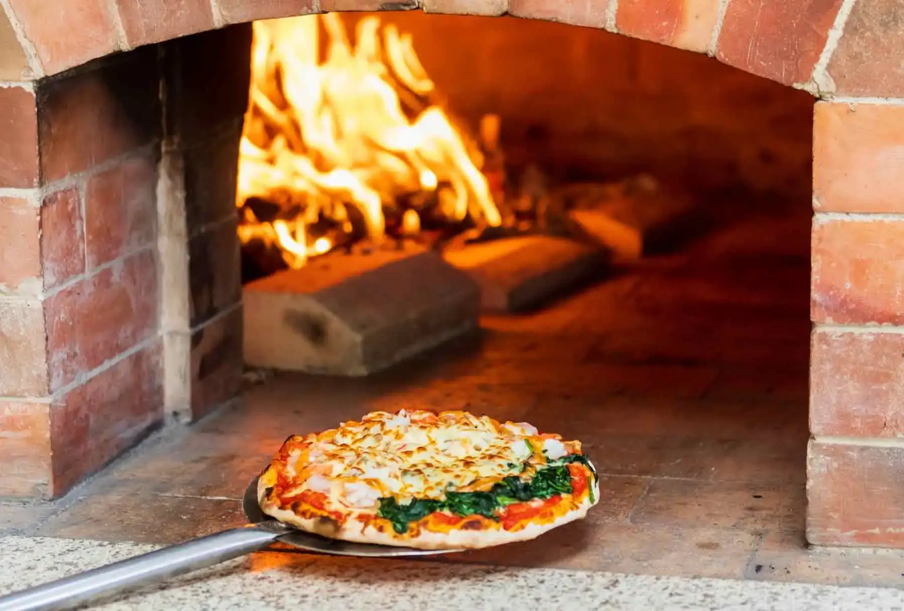 Pizza in a hot brick oven