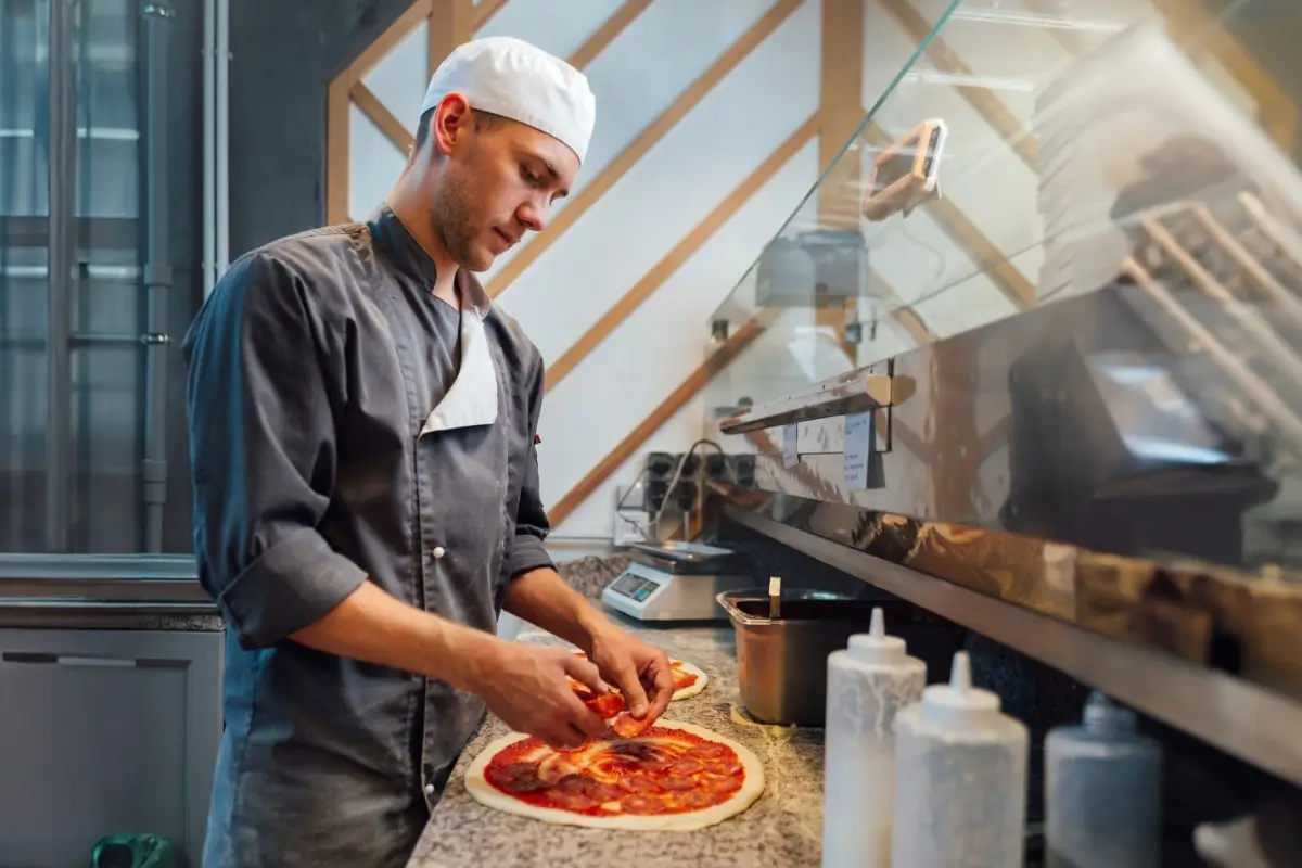 A chef preparing pizza